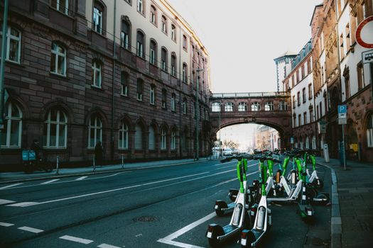 Street scene in Frankfurt am Main with electric scooters and historic architecture.