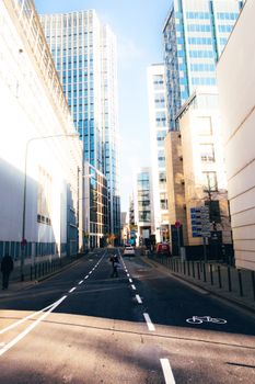 Daytime view of a modern street flanked by skyscrapers in Frankfurt.