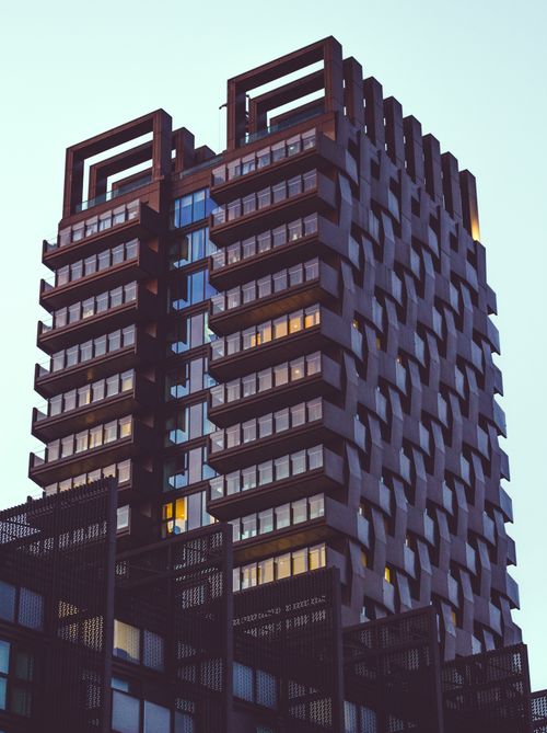 Free Contemporary skyscraper with distinctive facade under a clear sky. Stock Photo