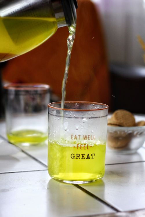 Free Close-up of a fresh lemon drink being poured into a clear glass with positive text. Stock Photo