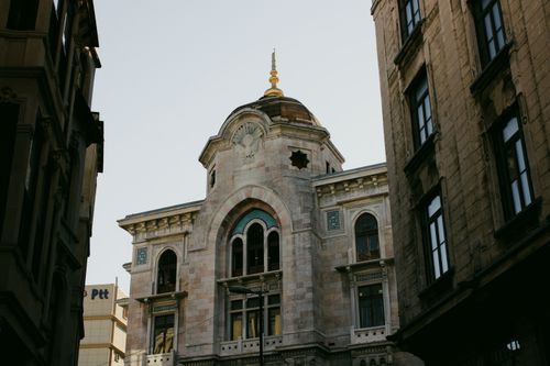 Free Classic European architectural building framed by urban setting under a clear sky. Stock Photo