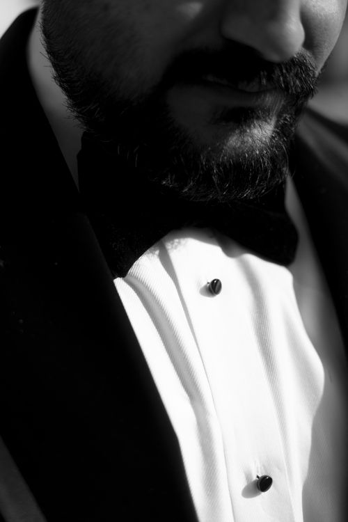 Free A close-up black and white portrait of a man in a tuxedo, capturing elegance and style. Stock Photo