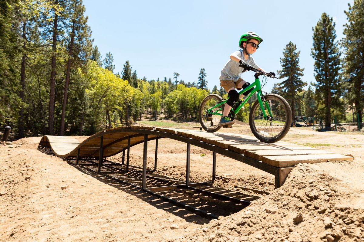 Kid jumping on bike pump track