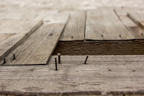 Free Detailed view of weathered wooden boards and nails, showcasing rustic texture. Stock Photo