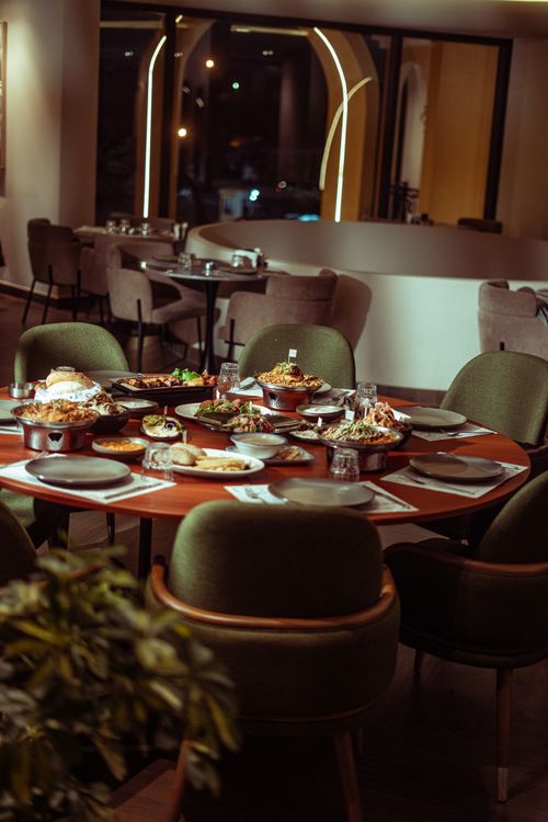 Free Elegant dining setup in a Baghdad restaurant with diverse Middle Eastern cuisine. Stock Photo