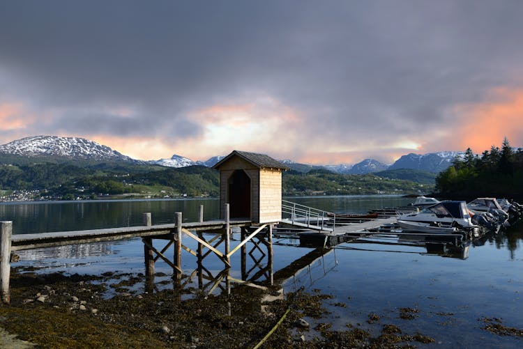 Scenic View Of The Majestic Mountains By The Docks In The Lake