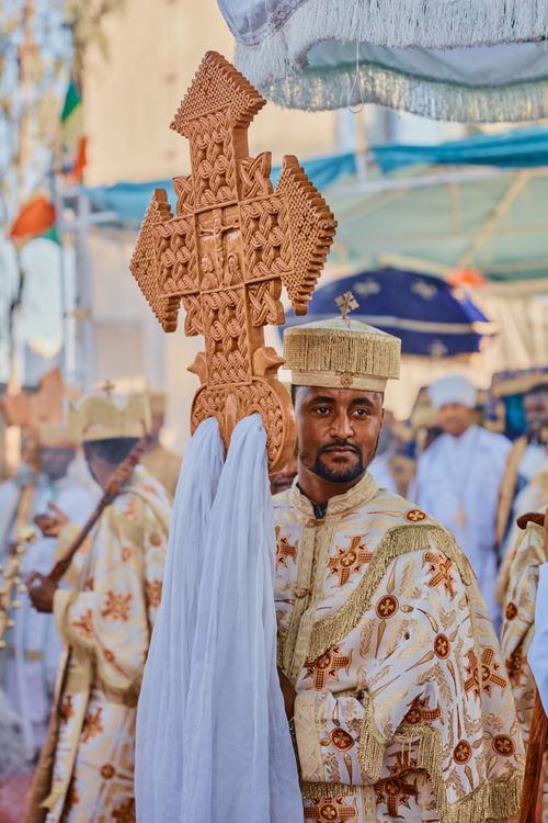 Free Traditional Ethiopian ceremony featuring a man holding an ornate wooden cross. Stock Photo