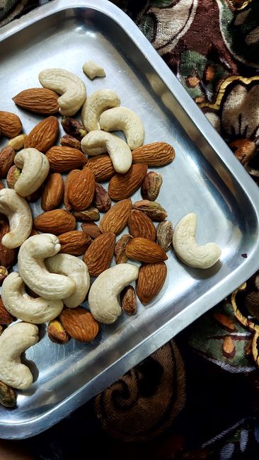 Close-up of assorted nuts on a metal tray, perfect for healthy eating concepts. - Key Indicators of Quality Dry Fruits