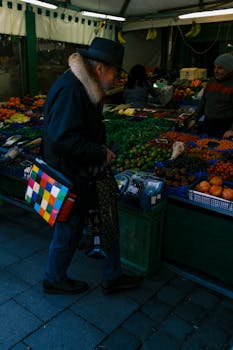Man exploring a colorful market in Munich, Bavaria. Vibrant fresh produce on display.