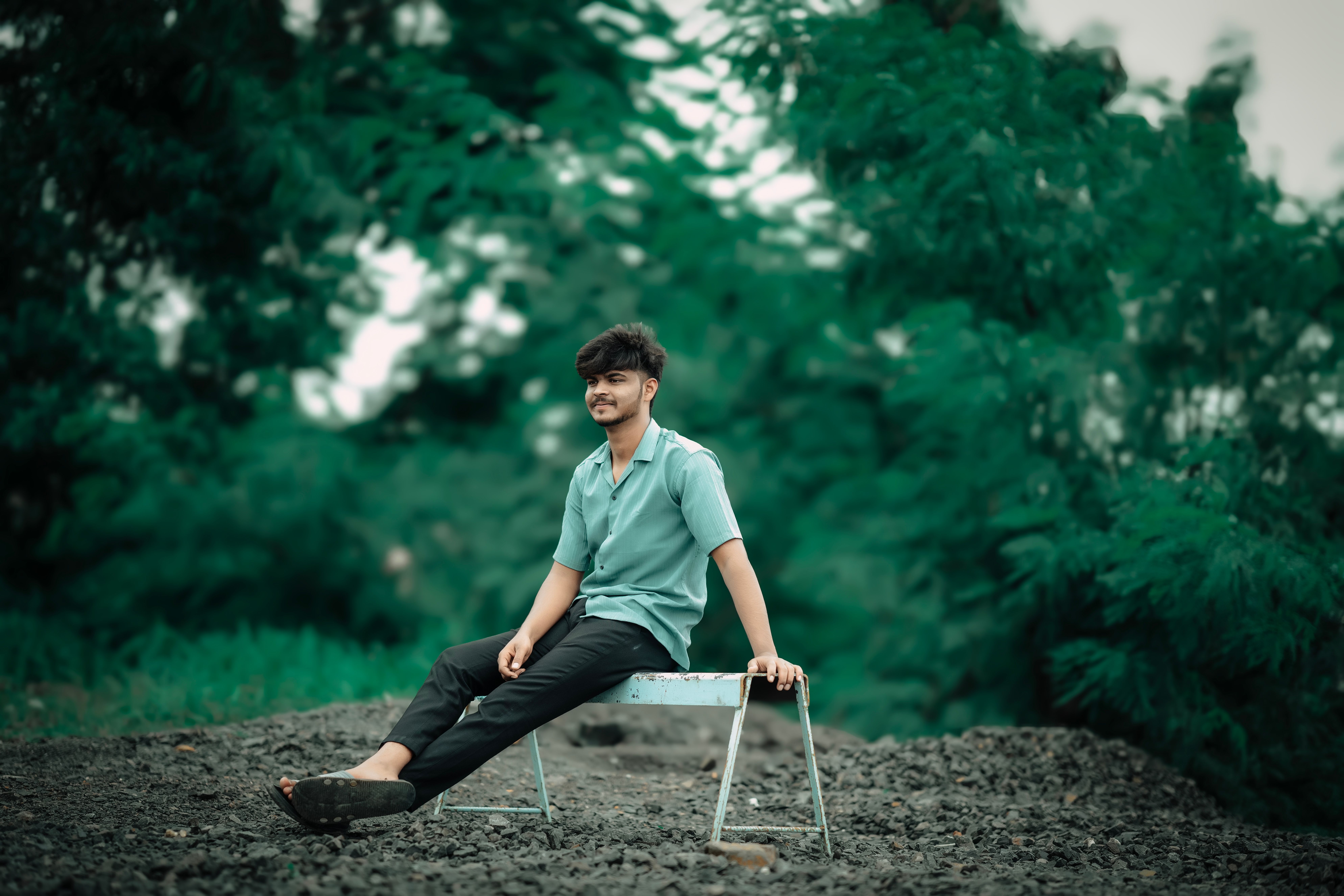 Young Man Sitting Outdoors on a Bench · Free Stock Photo