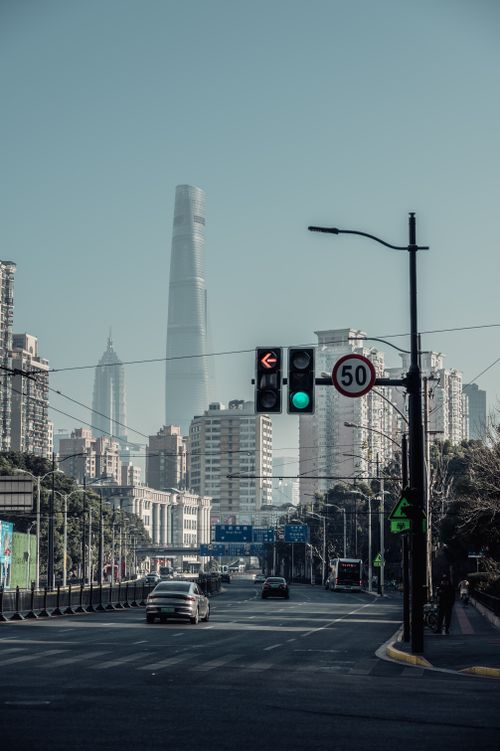 Free A dynamic view of Shanghai with skyscrapers and bustling traffic on a clear day. Stock Photo