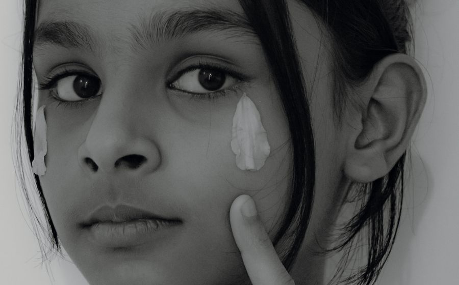 Patient applying prescribed serum after a medical facial