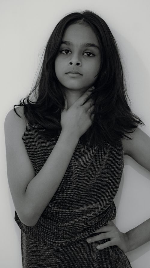 Free Monochrome portrait of a young woman posing gracefully against a plain background. Stock Photo