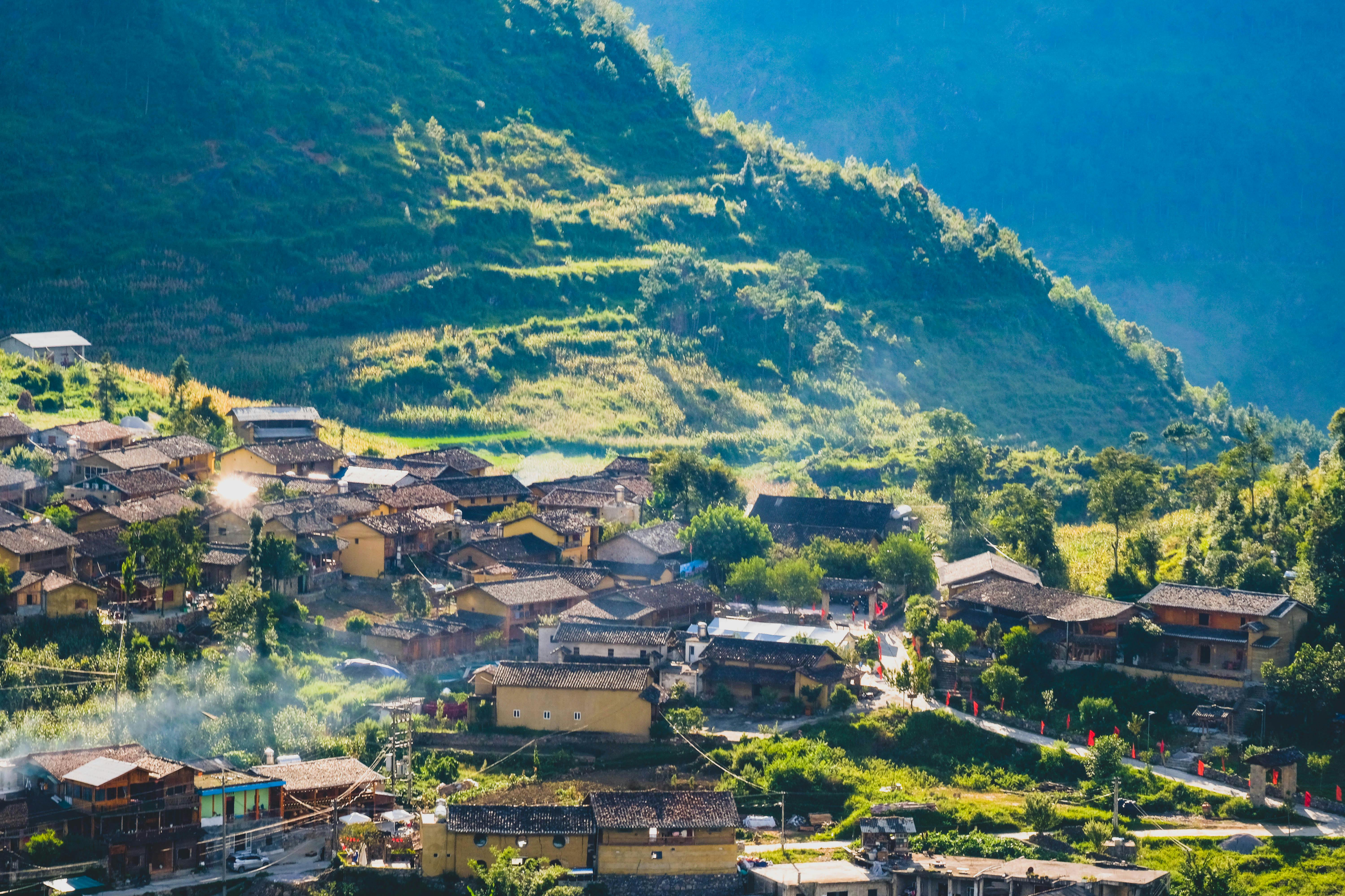 A picturesque village in Hà Giang, Vietnam, nestled among lush mountains and greenery.