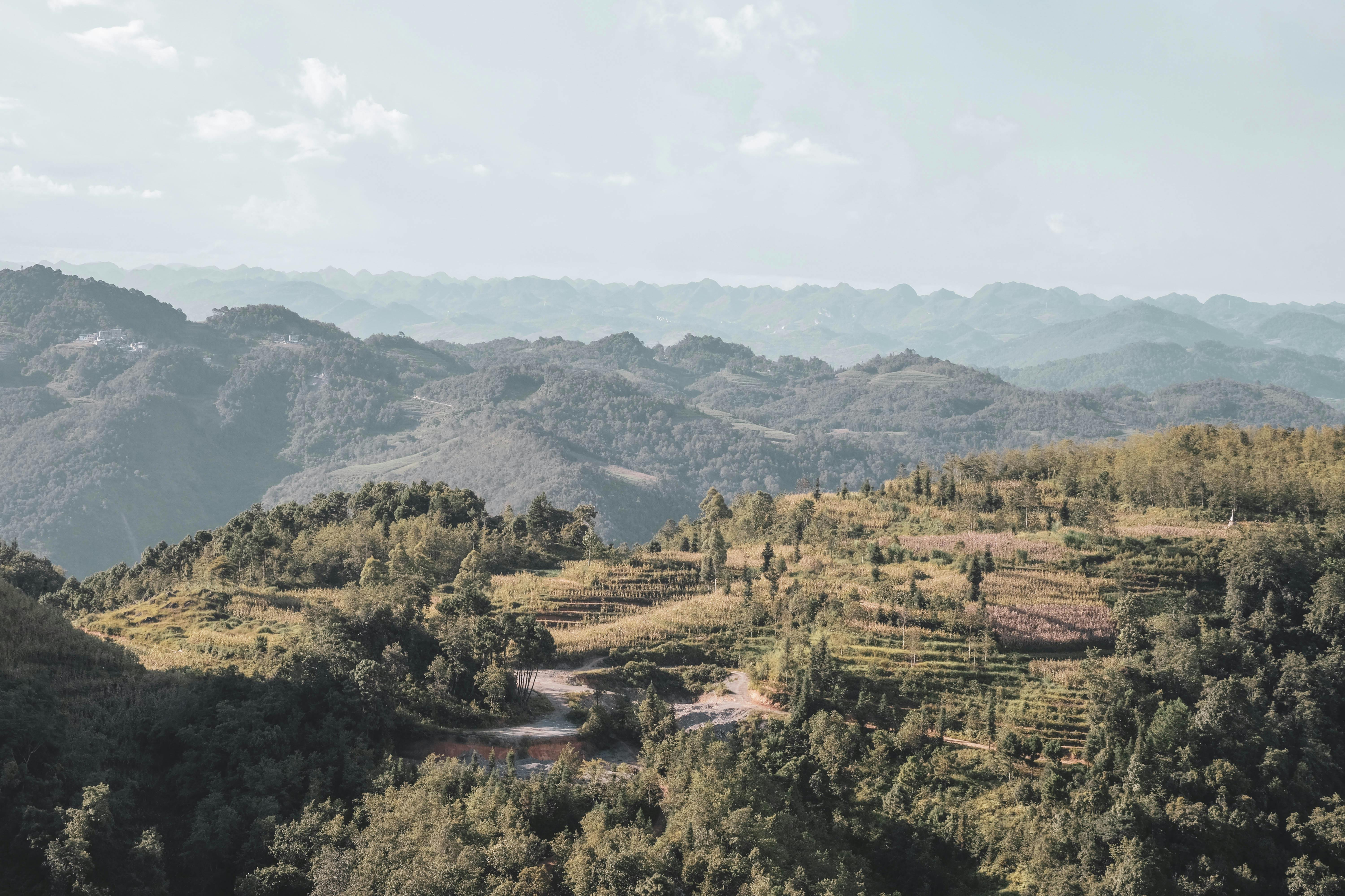 Breathtaking panoramic view of Hà Giang's lush mountains and clouds in Vietnam.