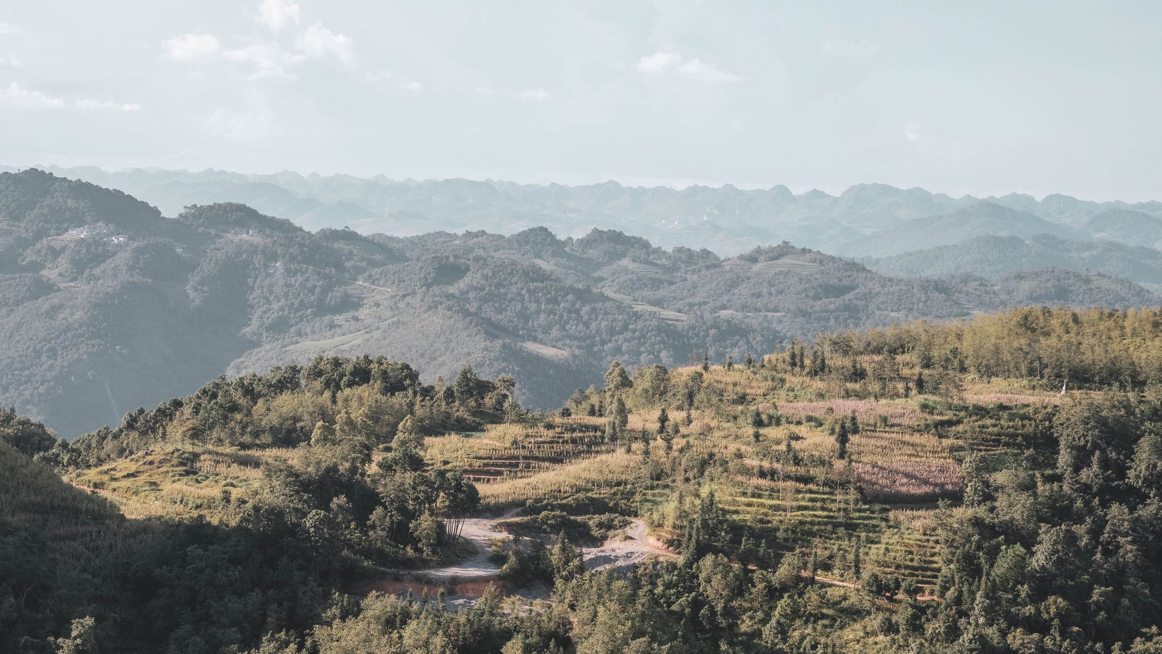 Breathtaking panoramic view of Hà Giang's lush mountains and clouds in Vietnam.