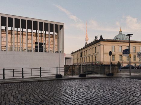Modern and classic Berlin architecture featuring the iconic Fernsehturm under a clear sky.