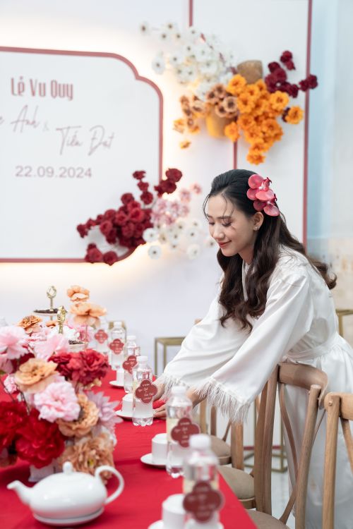 Free Woman arranging elegant floral and table settings at a wedding. Stock Photo