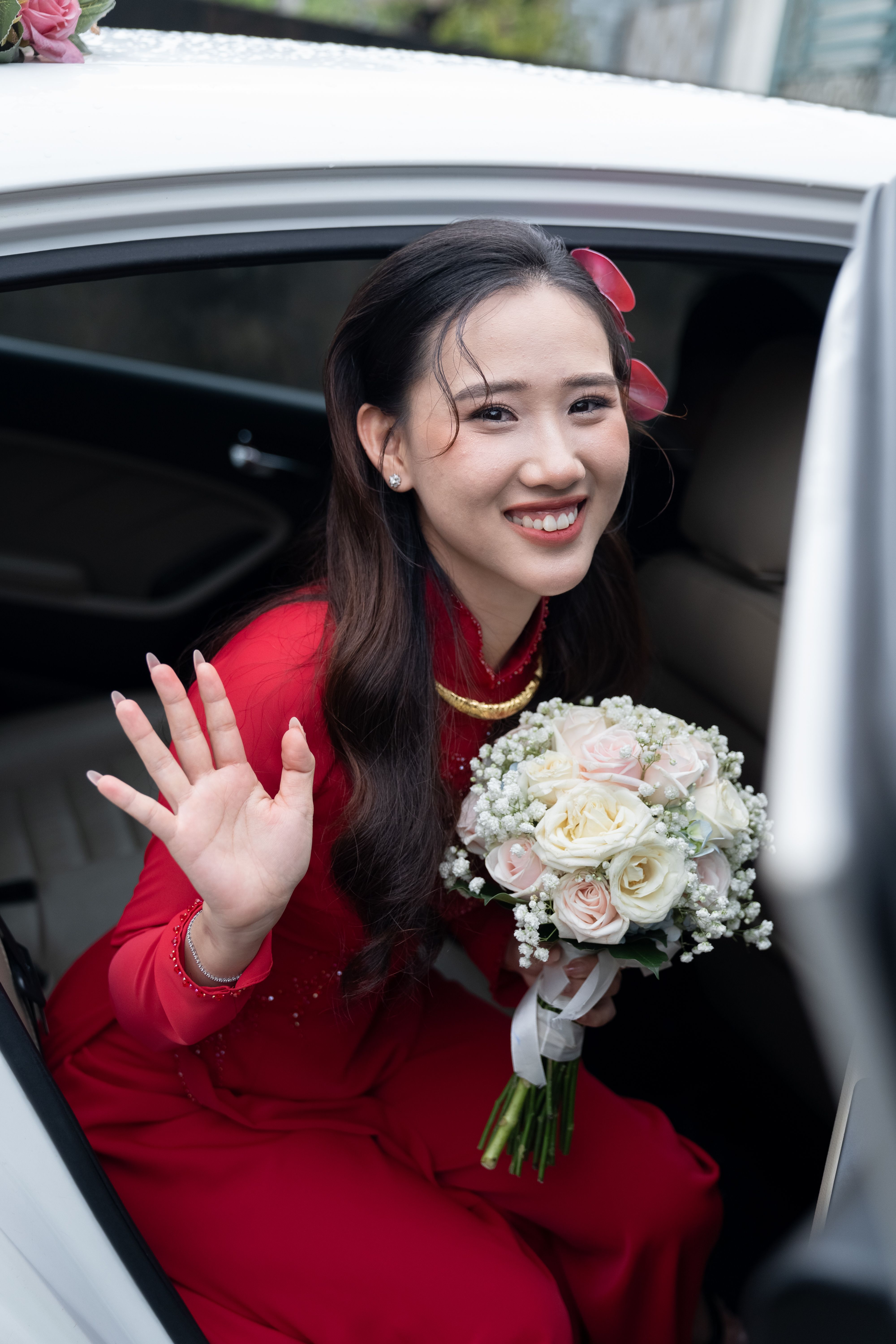 Bride Smiling in Red Dress Holding Bridal Bouquet · Free Stock Photo