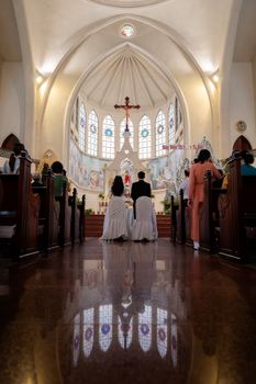 A serene wedding ceremony in a beautiful church with stained glass windows.