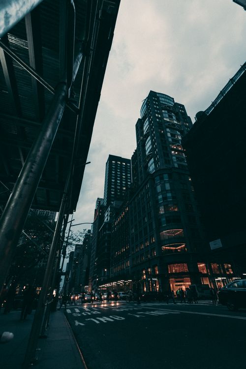 Free Dynamic street view of New York City featuring skyscrapers, bustling traffic, and an urban atmosphere. Stock Photo
