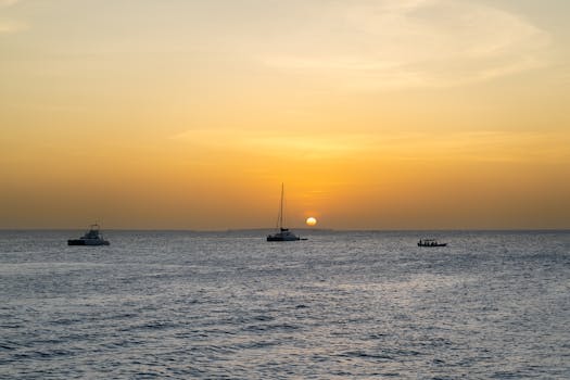 A tranquil view of boats at sunset on the Indian Ocean in Zanzibar.