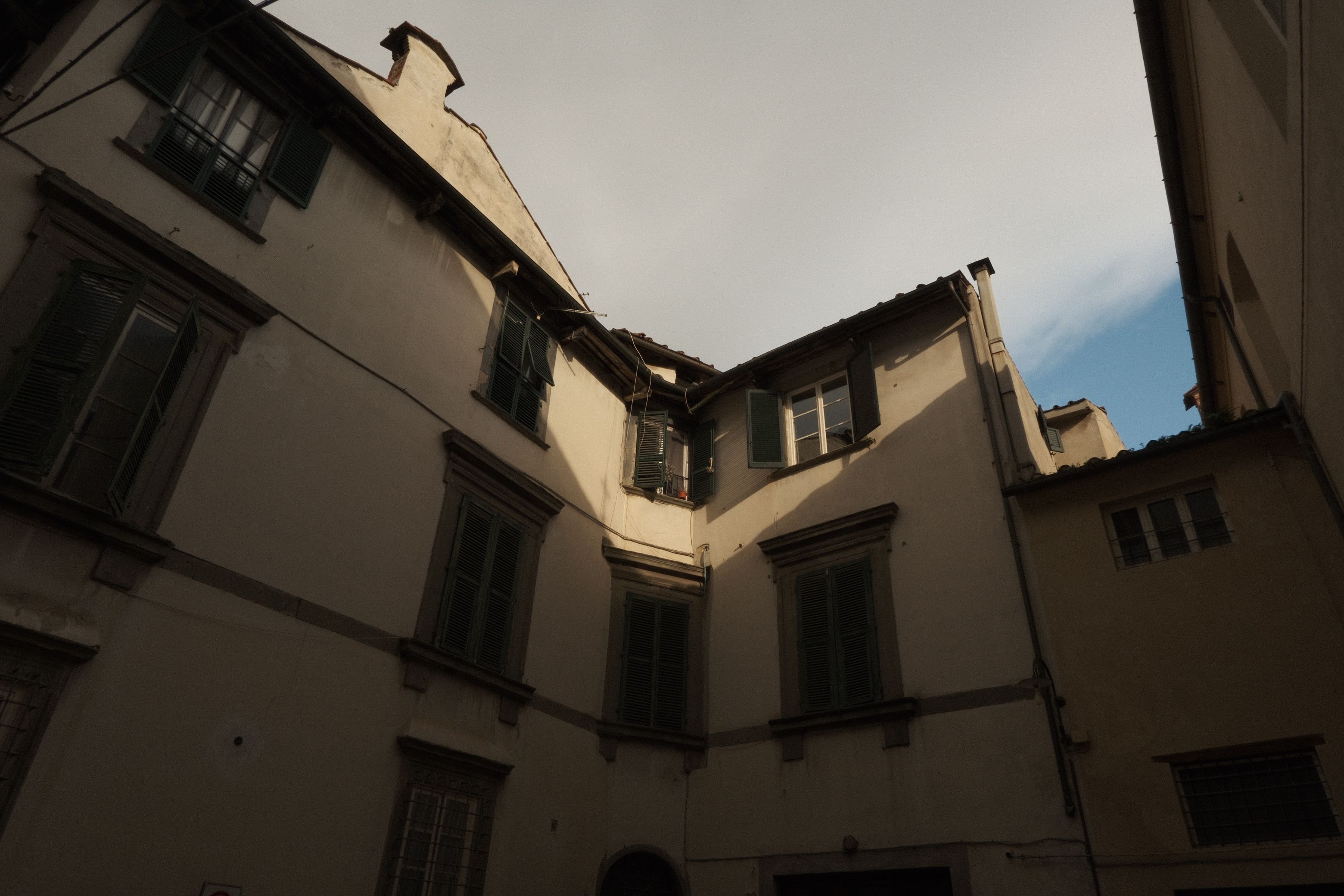 A quiet residential courtyard under overcast skies