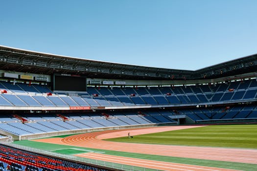Wide-angle shot of empty Nissan Stadium in Yokohama, Japan, with clear blue skies.