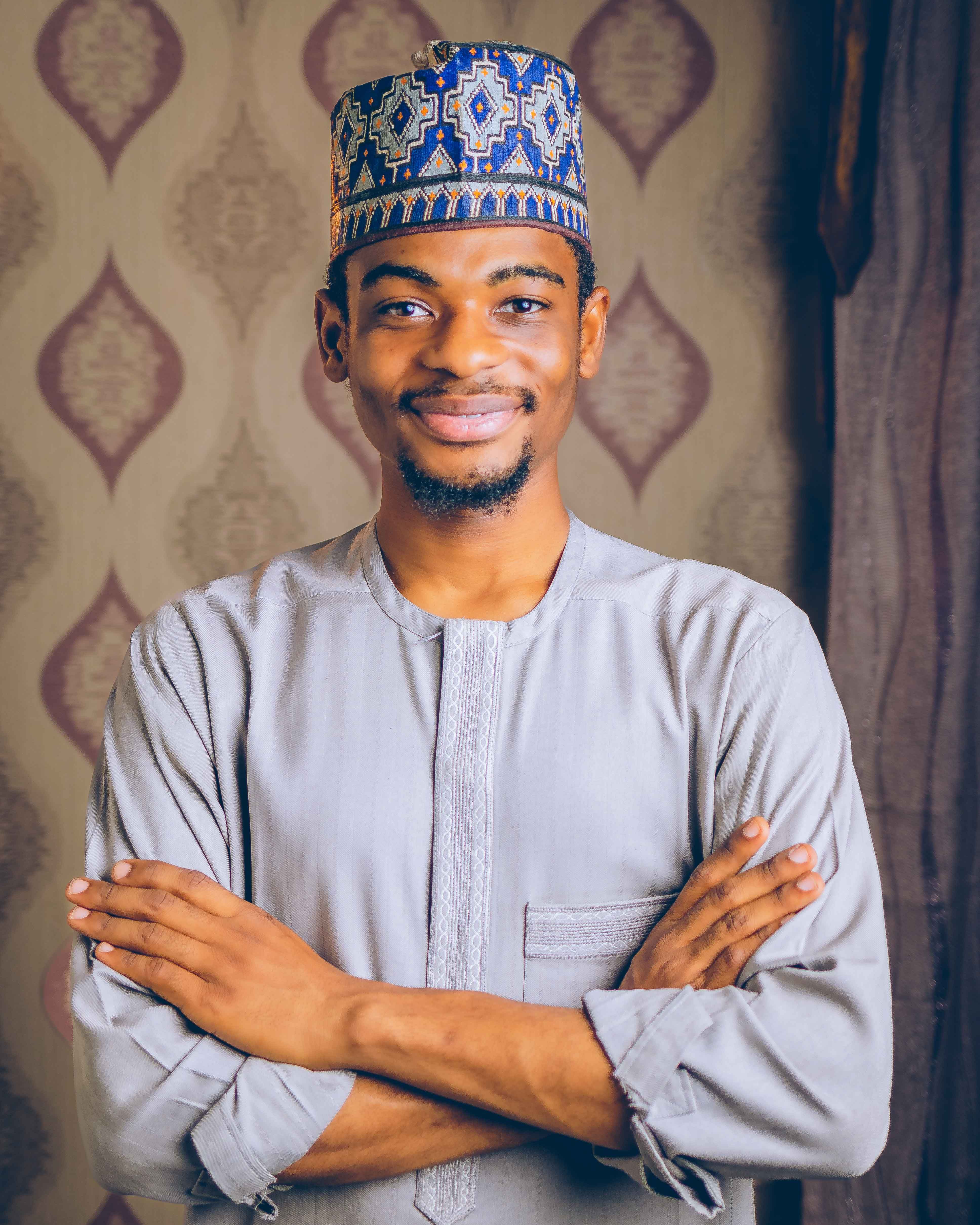 Portrait of a Smiling Man in Traditional Attire · Free Stock Photo