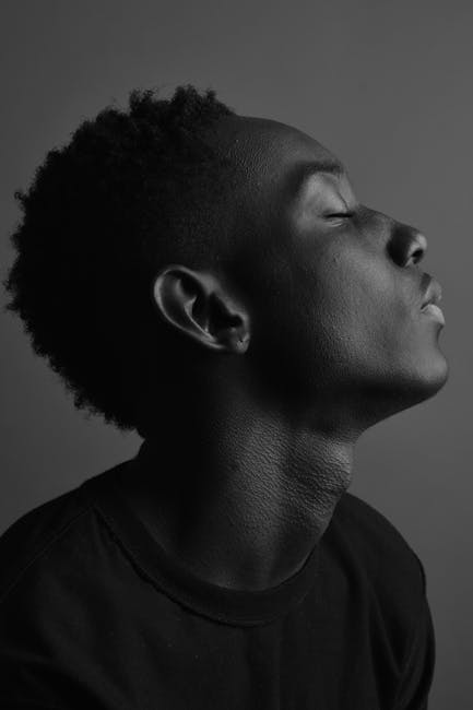 Artistic black and white side portrait of a man with eyes closed, captured in NY.