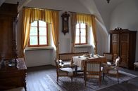 A classic dining room featuring antique wooden furniture and elegant decor in a cozy setting.