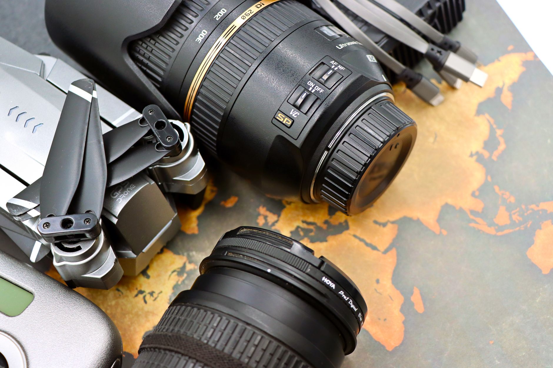 Camera gear and lenses on a vintage map for travel planning