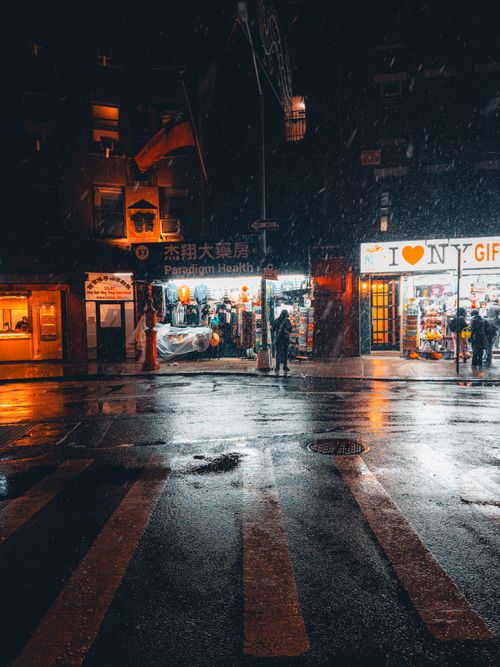 Free Moody urban street scene with neon lights and rain reflections. Stock Photo