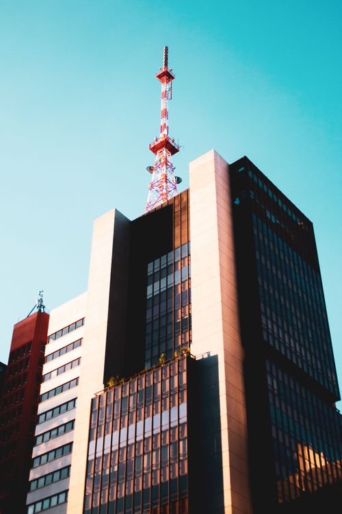 Free Urban skyline featuring a modern high-rise building and a communication tower in São Paulo. Stock Photo