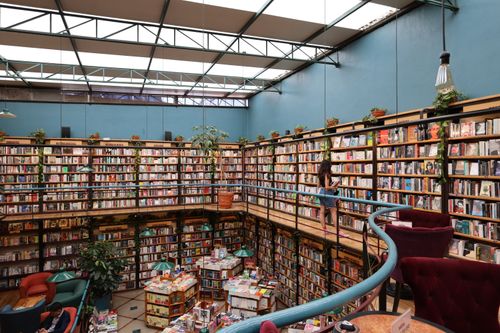 Free A vibrant library in Mexico City with towering bookshelves and readers exploring. Stock Photo
