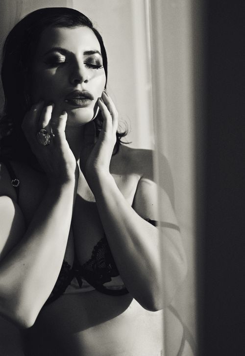 Free Artistic black and white portrait of a woman in lingerie reflecting emotion and mood. Stock Photo