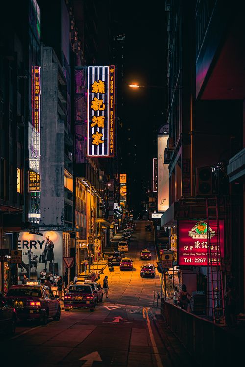 Free Explore the bustling streets of Hong Kong at night, showcasing vibrant neon lights and urban life. Stock Photo