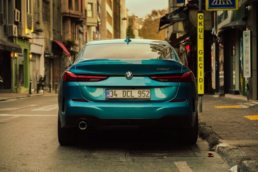 Rear view of a blue BMW 330d parked on a street in İstanbul with urban surroundings.