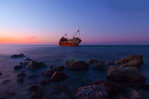 Free Captivating view of an abandoned ship at twilight amidst peaceful coastal rocks in Sri Lanka. Stock Photo