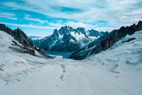 Snow-Covered Pathway Across Mountains