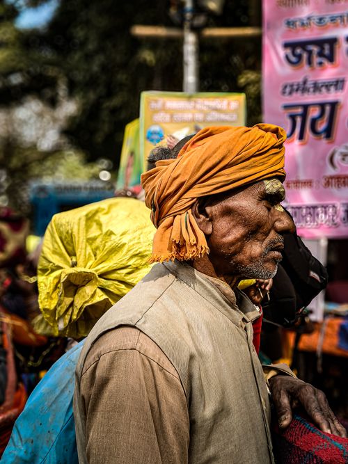 Free A colorful scene capturing a close-up of a man at a vibrant Indian street market. Stock Photo