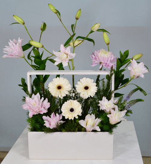 Free Chic floral arrangement with lilies and gerberas on display in Dubai. Stock Photo