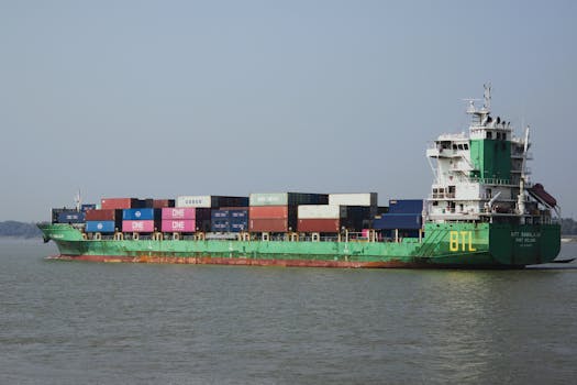 A container ship transporting goods across the ocean under clear skies.