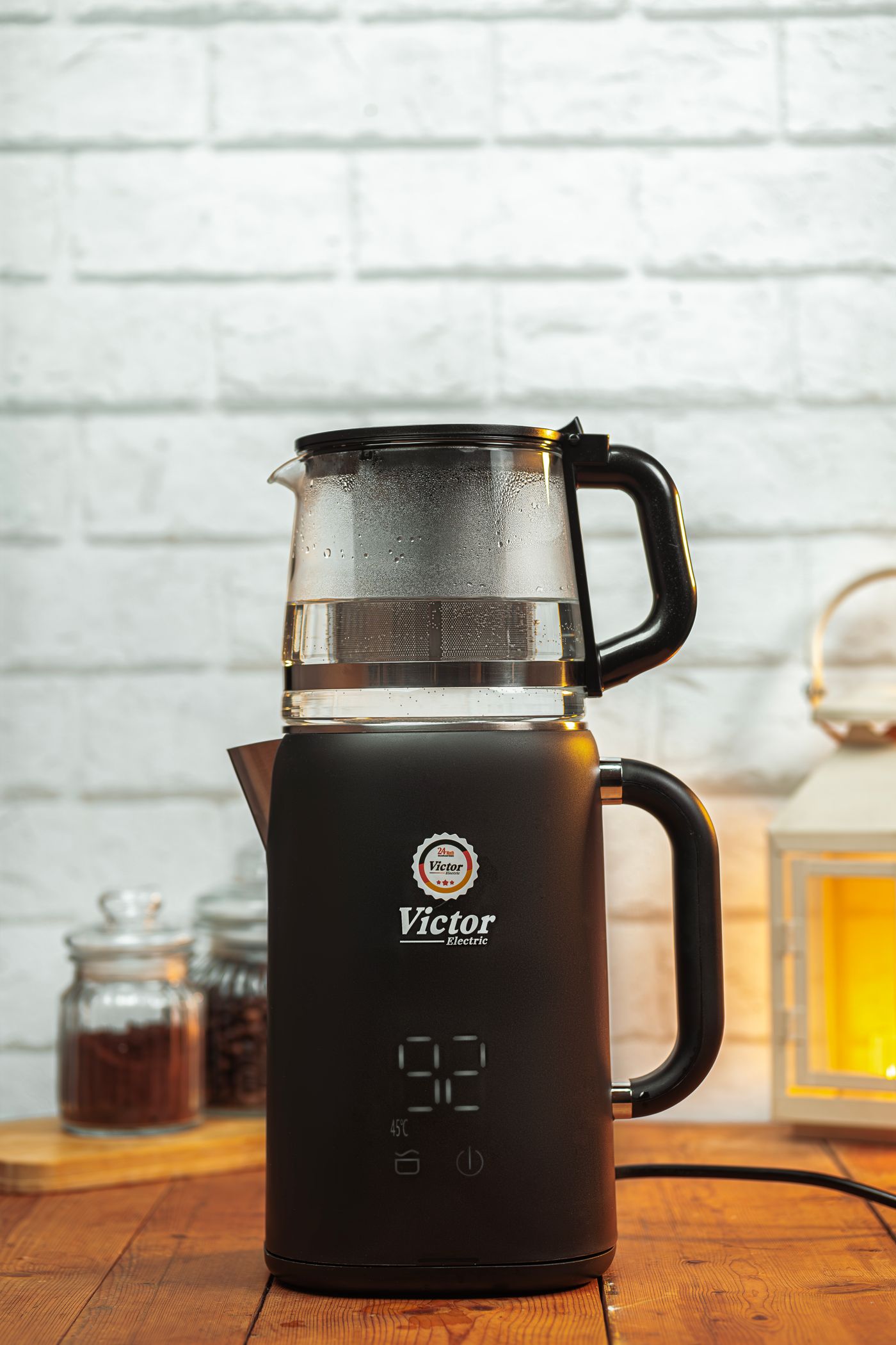 Modern black electric kettle on a warm kitchen counter