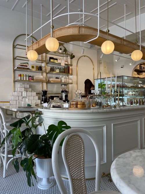 Free Cozy vintage-style cafe interior with plants and elegant decor. Stock Photo