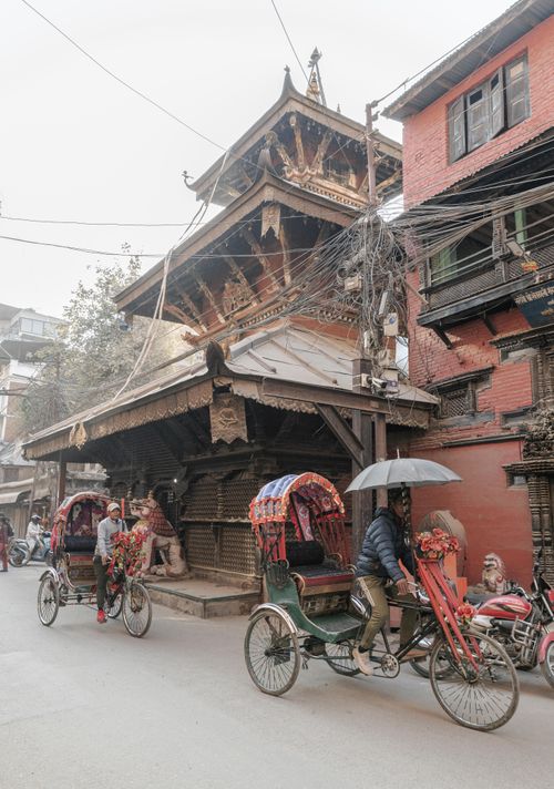 Free Explore the vibrant street life of Kathmandu with traditional rickshaws and heritage architecture. Stock Photo
