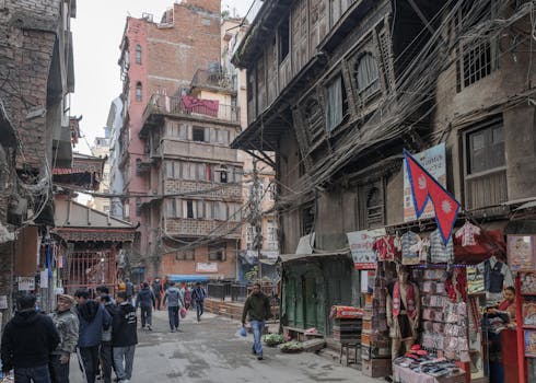 Bustling street in Kathmandu with traditional architecture and local market stalls.