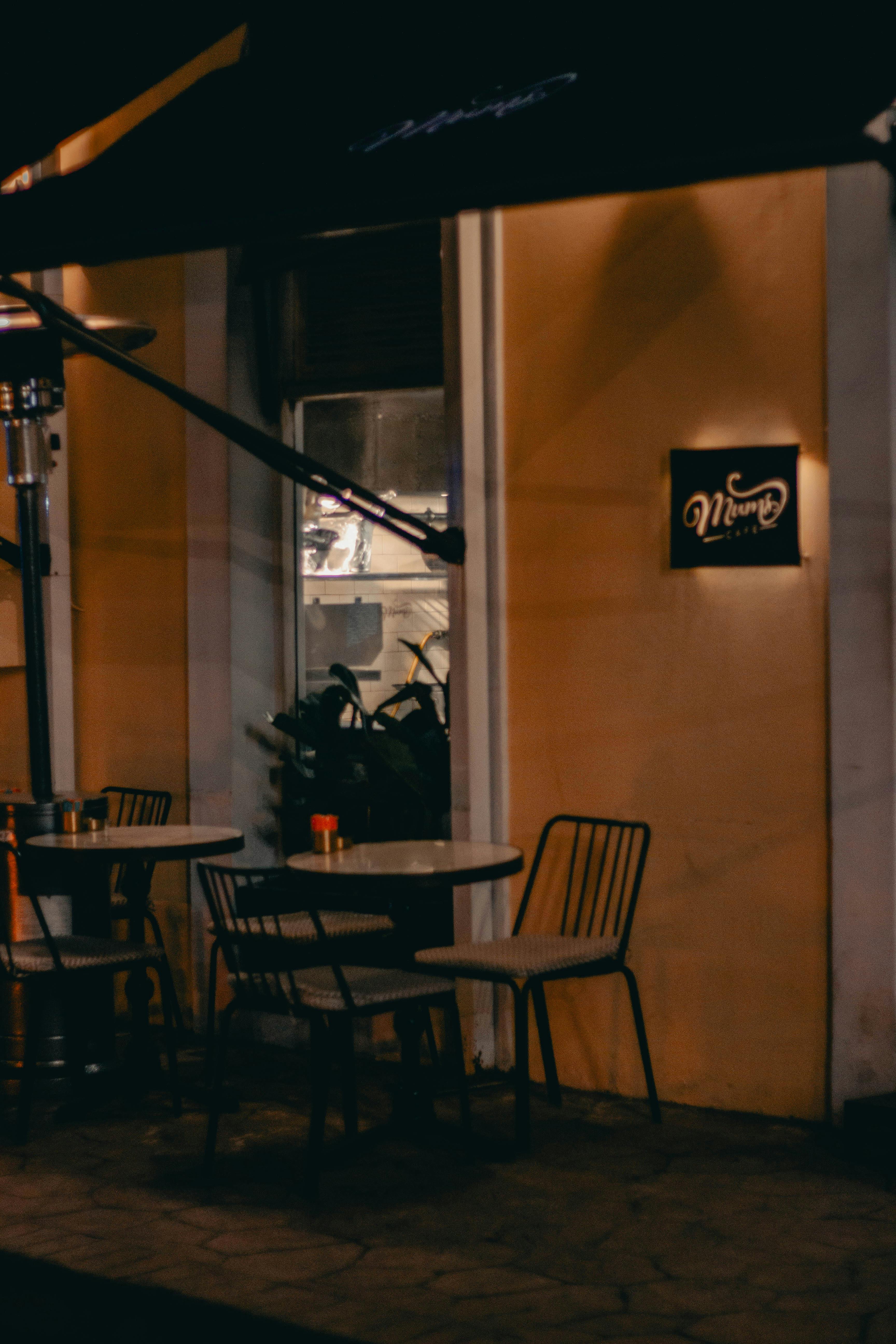 Kostenlos Eine bezaubernde Straßencafé-Szene, aufgenommen bei Nacht in Istanbul, mit leeren Stühlen und warmer Beleuchtung. Stock-Foto