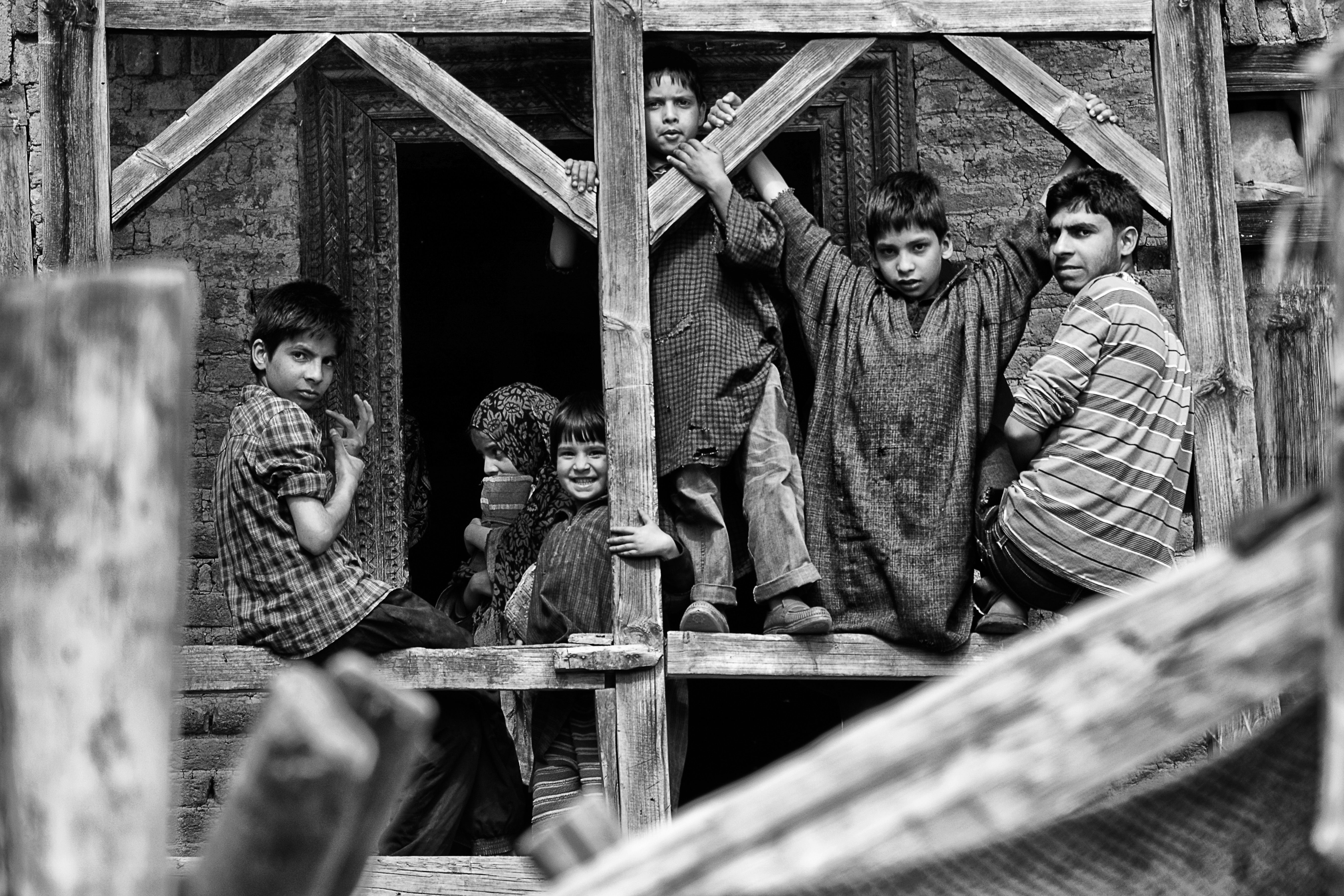 Children Posing in Rustic Wooden Frame · Free Stock Photo