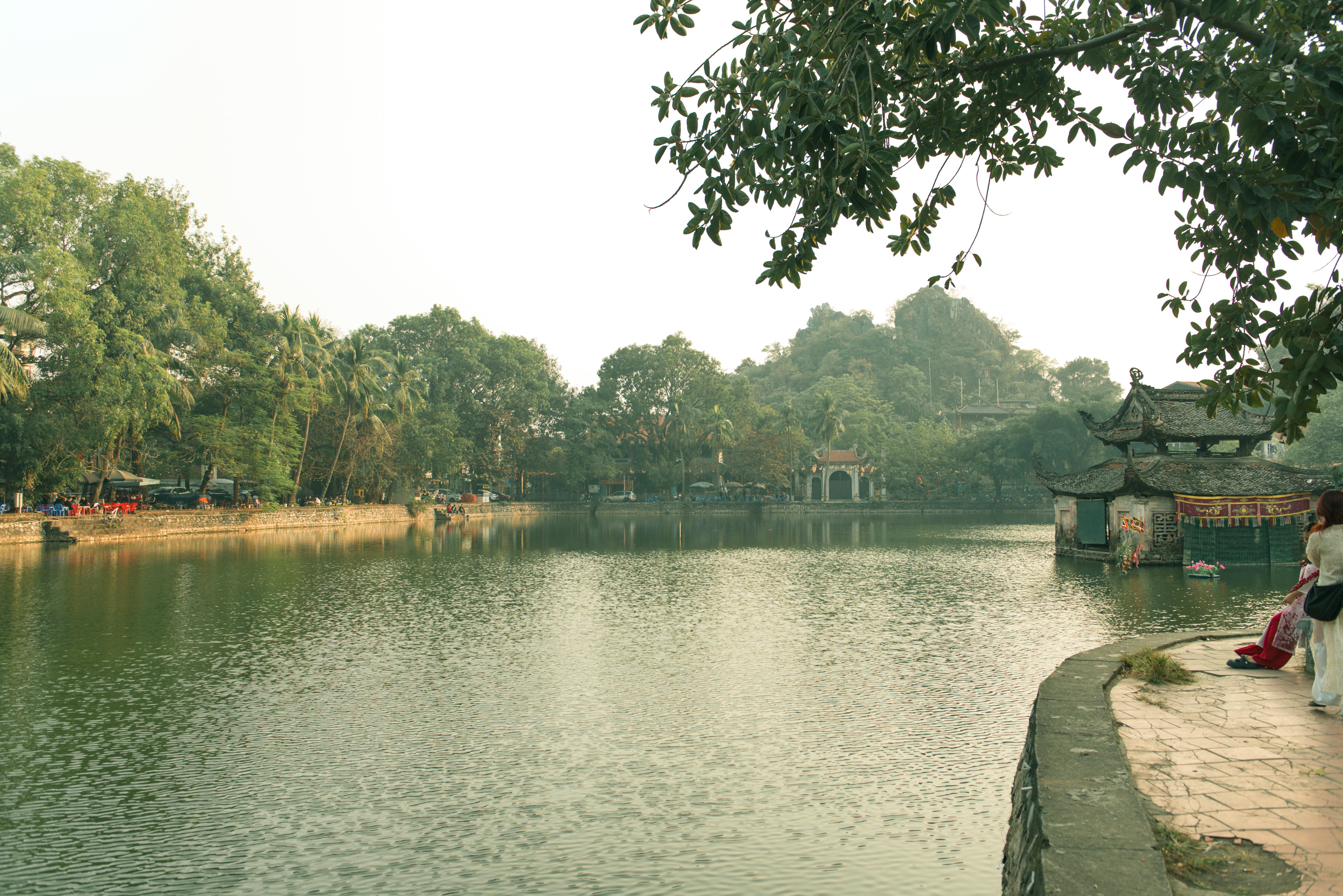 Tranquil scene at West Lake in Hanoi, capturing lush greenery and traditional architecture.